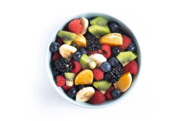 istock Fruit salad in a blue bowl isolated on white background 2161302968