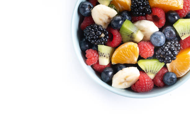 istock Fruit salad in a blue bowl isolated on white background 2161302986
