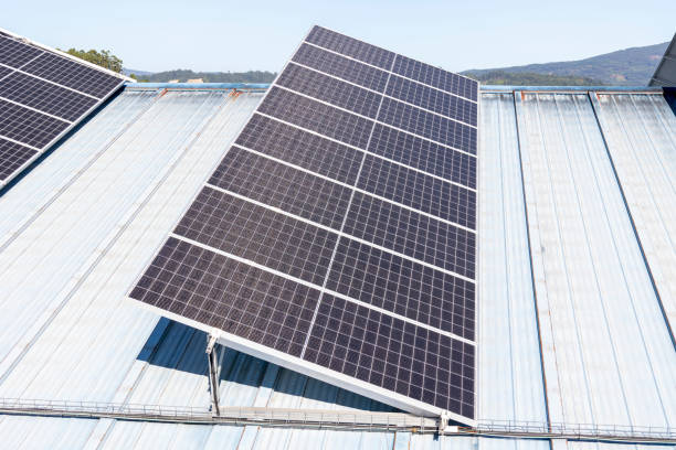 istock Solar panels on a metal roof under clear blue sky 2161304888
