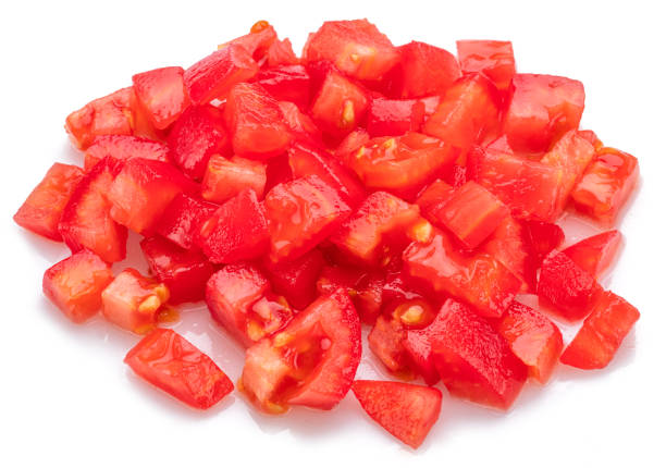 istock Peeled and diced fresh tomatoes isolated on white background. Macro shot. 2161304947