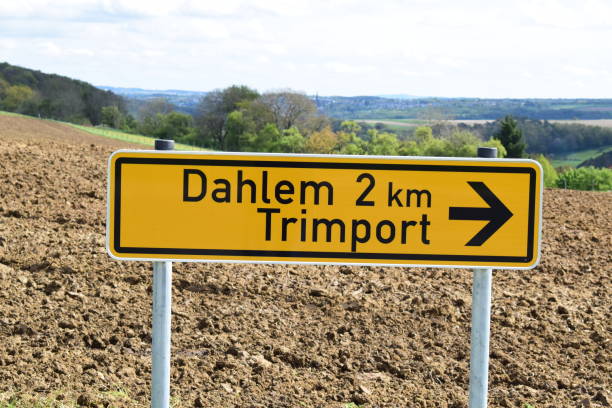 istock sign towards two towns, Dahlem, Trimport 2161308029