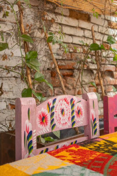 istock Colorful Decorative Wooden Chair with Floral Patterns in Rustic Setting 2161312815