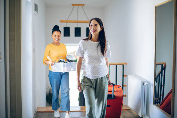 istock Female couple having fun while moving in their new apartment 2161313020