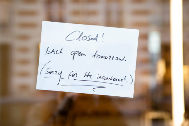istock Handwritten closed sign in a shop window 2161313494