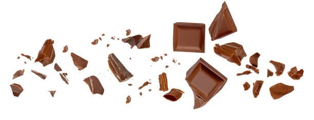 istock  Levitating milk chocolate chunks isolated on white background. Broken chocolate bar pieces and cocoa crumbs explotion  on white background. Chocolate collection 2161313621