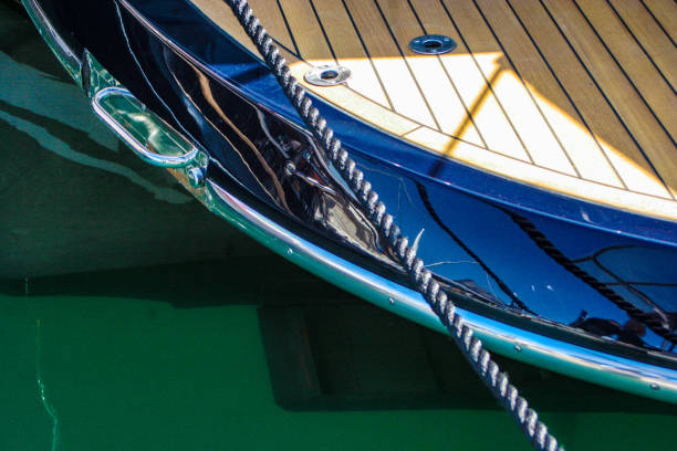 Genova, Liguria, Italy - Aprile 4th 2008 - \nA luxury yacht moored with a rope, showing a polished deck and reflective blue hull