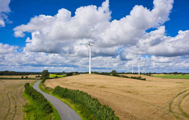 istock One lane road and wind turbines in rural district 2161316714