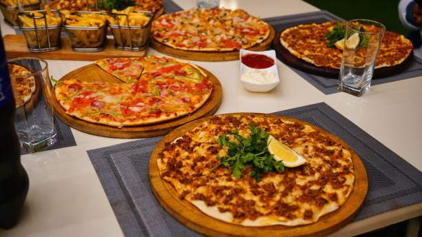 istock Variety of Pizzas on Table With Drinks 2161317378