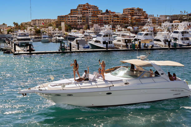 Cabo San Lucas, Mexico - 14 January 2024: Speedboat with people on the front deck leaving the harbour of Cabo San Lucas