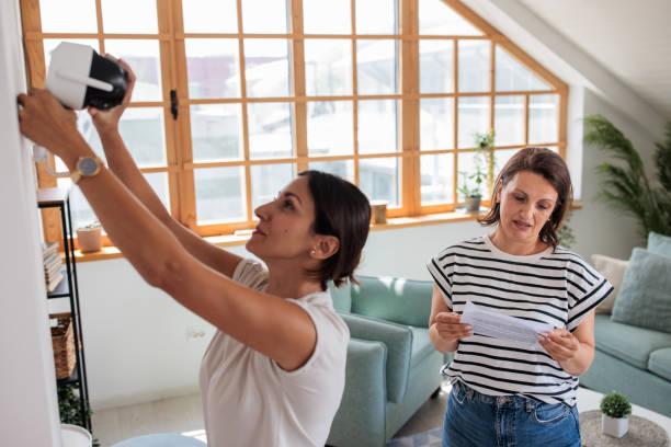 istock Two women installing a home surveillance camera 2161322312