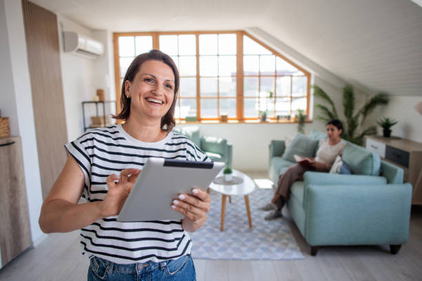 istock Woman using a tablet in her home 2161322466