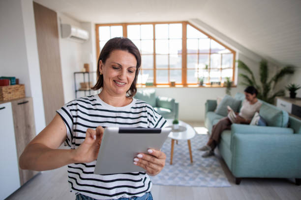 istock Woman using a tablet in her home 2161322507