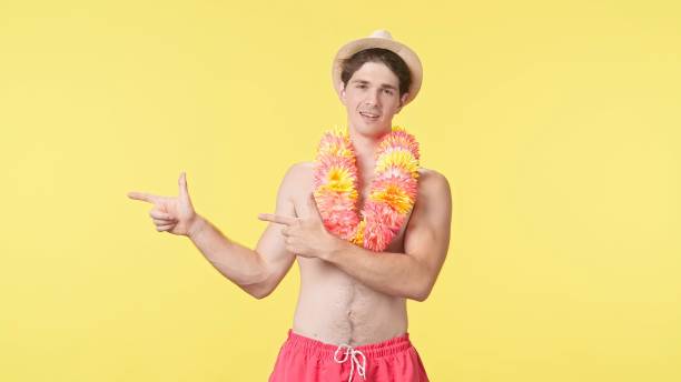 istock A young man points his finger sideways at the workspace. 2161327450
