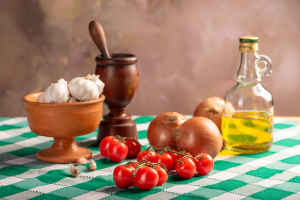 Table with ingredients and utensils on a green and white tablecloth, selective focus.