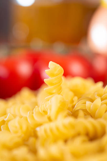 Pasta, table with pasta, ingredients and utensils, selective focus.