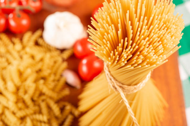 Pasta, table with pasta, ingredients and utensils, top view.
