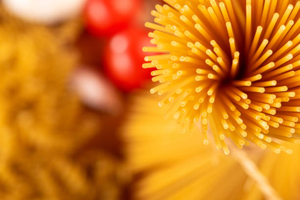 Pasta, table with pasta, ingredients and utensils, top view.
