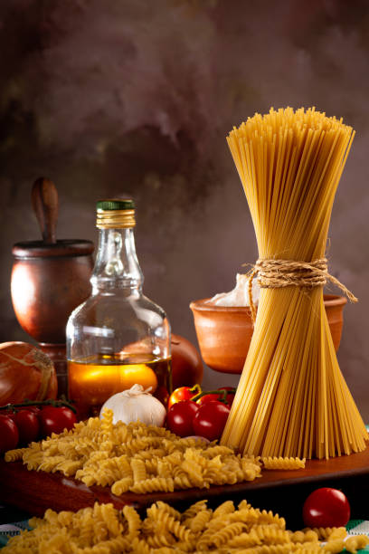 istock Pasta, table with pasta, ingredients and utensils, selective focus. 2161329040