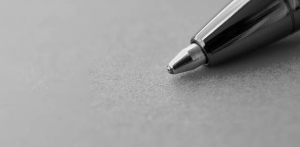 Close up of pen with customizable space for text or ideas with black and white background. Author and writing concept.