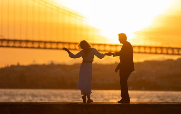istock A couple is dancing on a pier by the water 2161331119