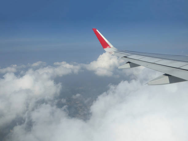 View from airplane window on plane wing and cloudy sky