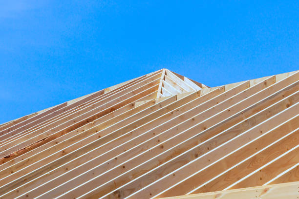New frame building is under construction with rafters, roof beams, construction framework