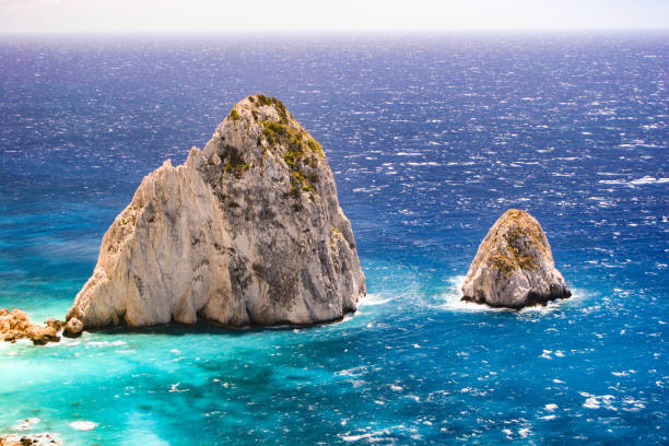 Kerì, Zakynthos, Greece - August 5th 2005 - \nTwo rocky islets in the turquoise sea, with sparkling waves and under a bright sun