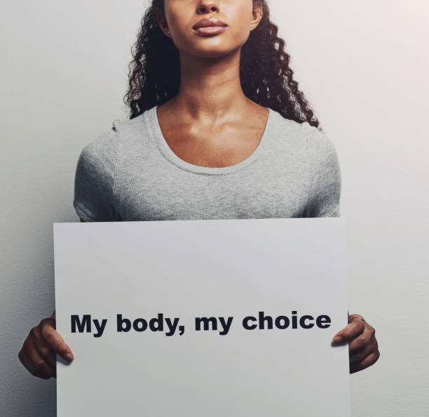 Woman, hands and poster with message for notification, text or empowerment on a white background. Female person, studio or model with billboard, sign or note for protest, awareness or choice