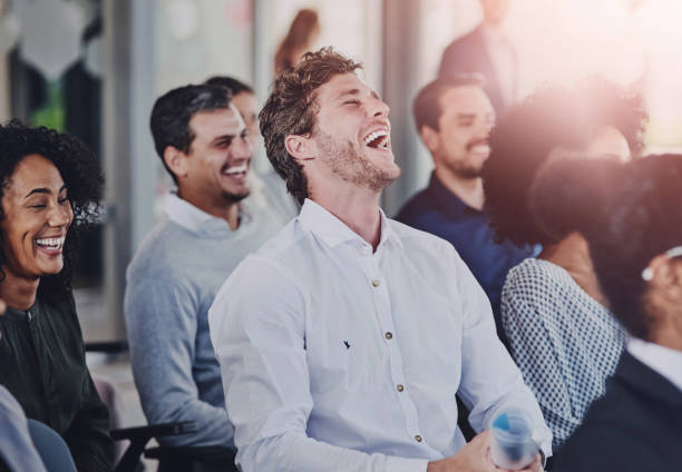 istock Education, development and seminar with funny business people in conference room for learning or training. Corporate, laughing at workshop with man and woman employee group in audience at office 2161338286