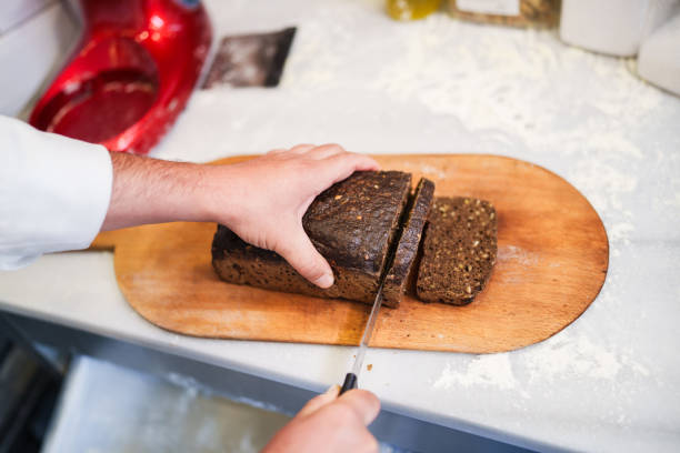 istock Slicing black bread at the bakery 2161338401