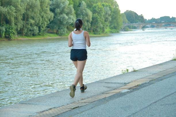 istock Active girl jogging near the river 2161343115