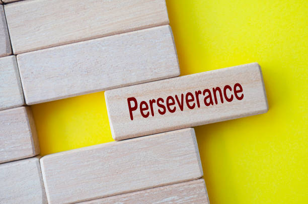 istock Perseverance text written on wooden blocks with yellow cover background 2161343533