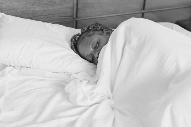istock A black woman sleeping peacefully in her bed 2161346441