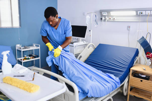 istock Man changing bed sheets at the hospital 2161348904