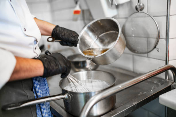 istock Pouring syrup over the cream in cooking pan. 2161349158