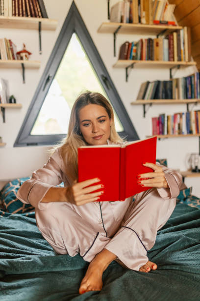 istock Beautiful woman reading book in a mountain hut 2161349862