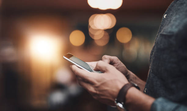 istock Man, typing hands and phone internet for social media, email notification and connection for search. Male person, fingers and mobile for chat app, message and online invitation for restaurant launch 2161350938
