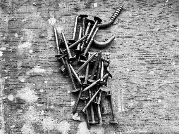 A know assortment of metal nails and screws on a table