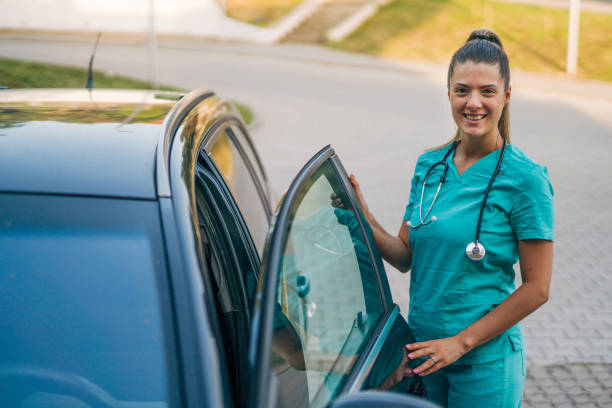 istock young female nurse get in car after work 2161351712