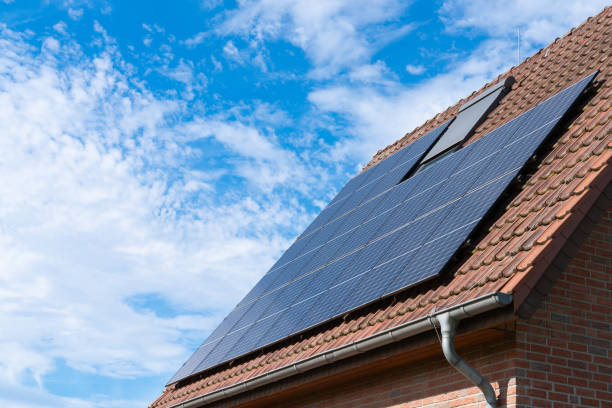 istock Solar panels on roof against blue sky 2161352116