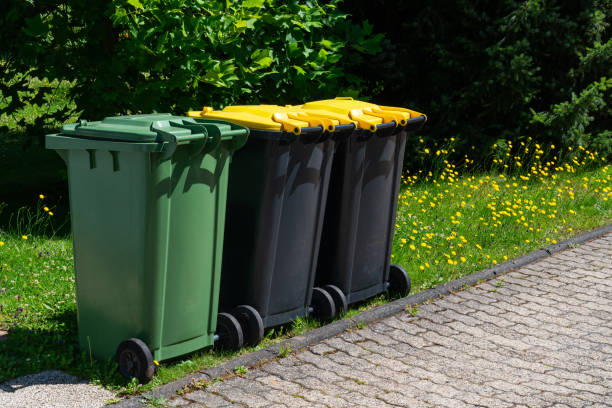 istock Green and yellow recycling bins on curb 2161352736