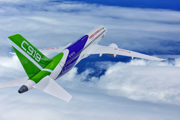 April 7, 2024, Shanghai - China: Aerial View of the C919 Aircraft Flying at Mid-Air Sky. The C919 aircraft is a single-aisle narrow-body aircraft and a medium-range mainline jet aircraft. It is developed and produced by Comac Company.