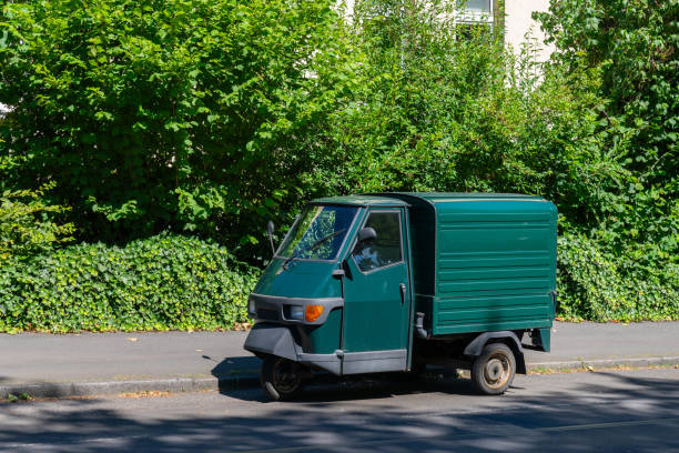 istock Green delivery truck parked on sidewalk 2161353095