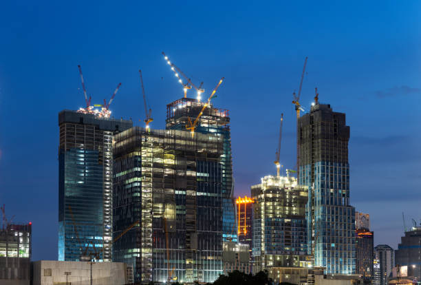 istock construction worker with crane. Hook cargo crane on the sky background. crane on a construction site 2161354417