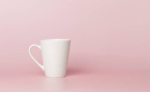 istock white cup for tea or coffee on a pink background 2161354959