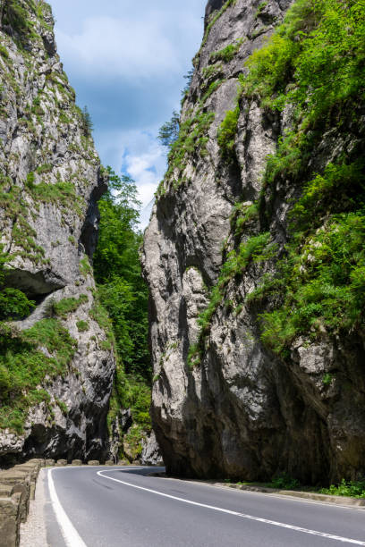 istock A road passing through a canyon with rocky cliffs on each side 2161357084