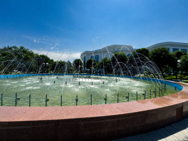 Fountain in garden on Alisher Navoy Street, in downtown Tashkent with the National Library in the background