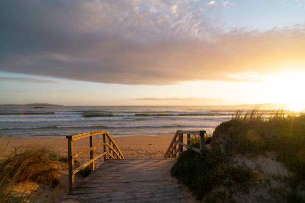 istock A wooden bridge leads to the beach. 2161361212