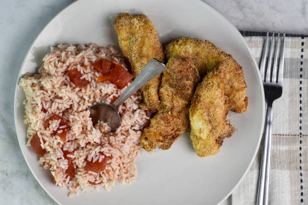 istock chicken tenders   with  rice and tomatos 2161361732