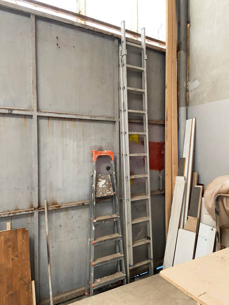 Tall and small ladders in a warehouse